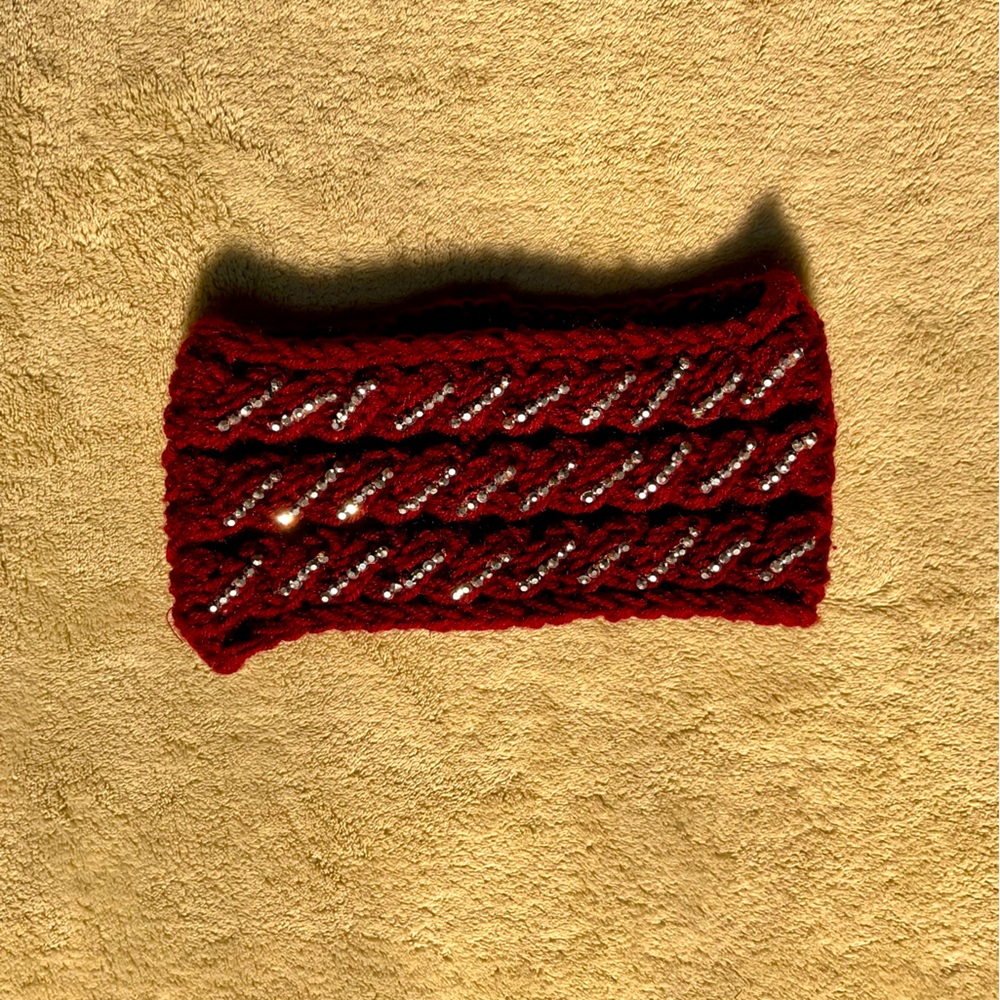 Red knit headband with silver embellishments to keep you stylish and warm